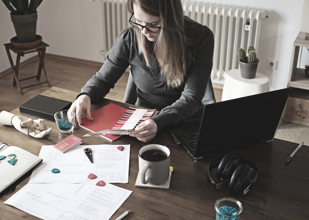 Hands working on loan paperwork at a desk