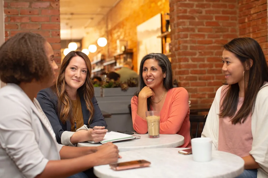 Diverse group of women business owners in a community funding meeting