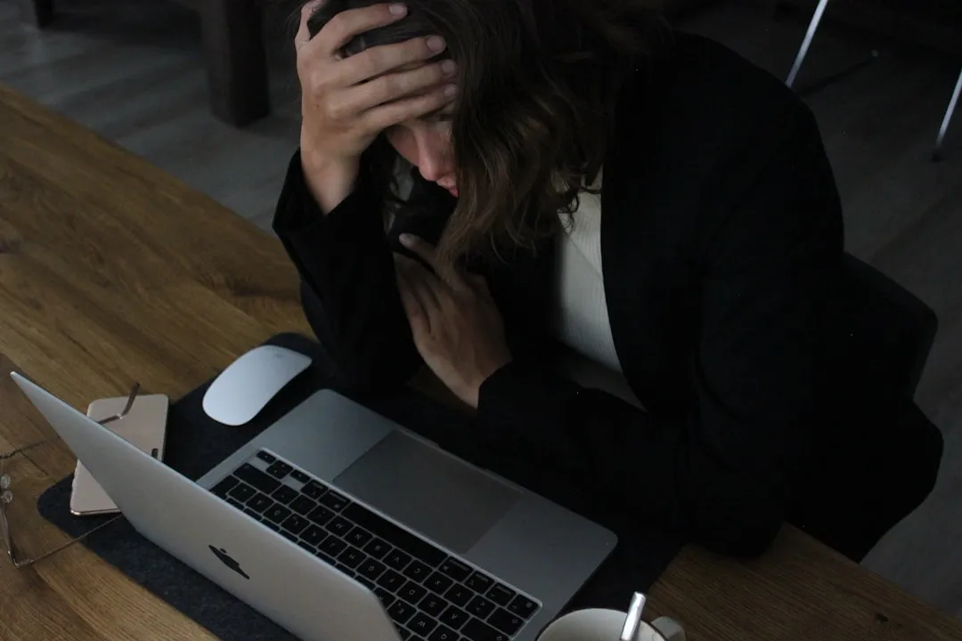 Stressed woman business owner at her desk during a cash crisis