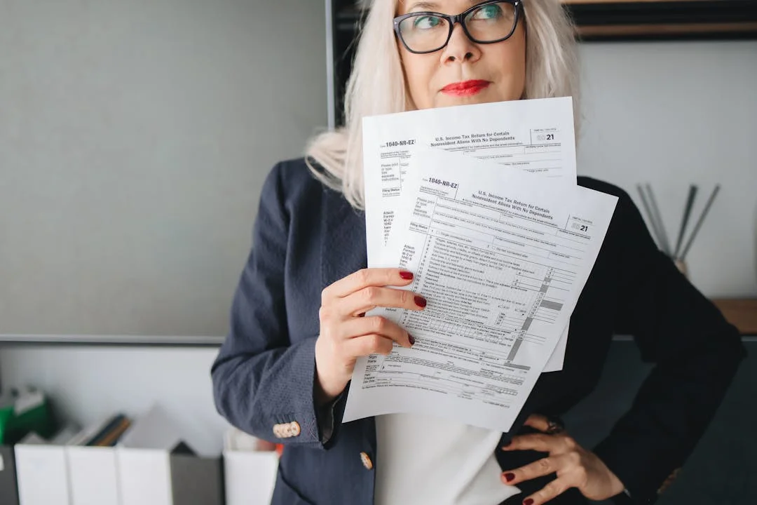 Confident woman business owner reviewing financial documents in a professional office