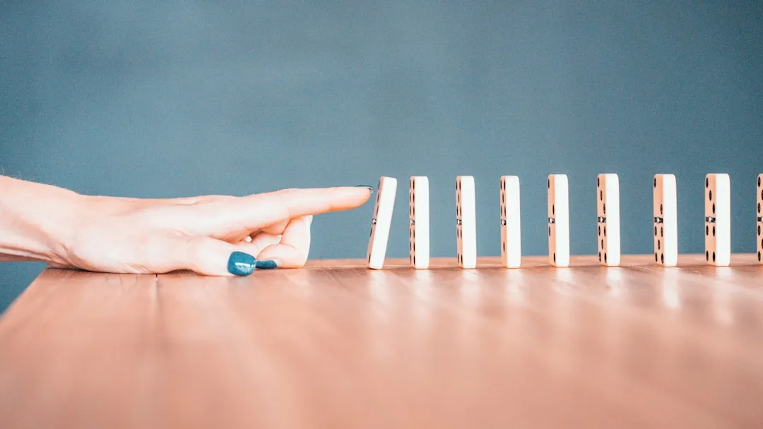 Dominoes falling in a chain reaction cascade