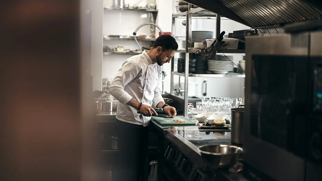 Woman professional in a commercial kitchen managing food production operations