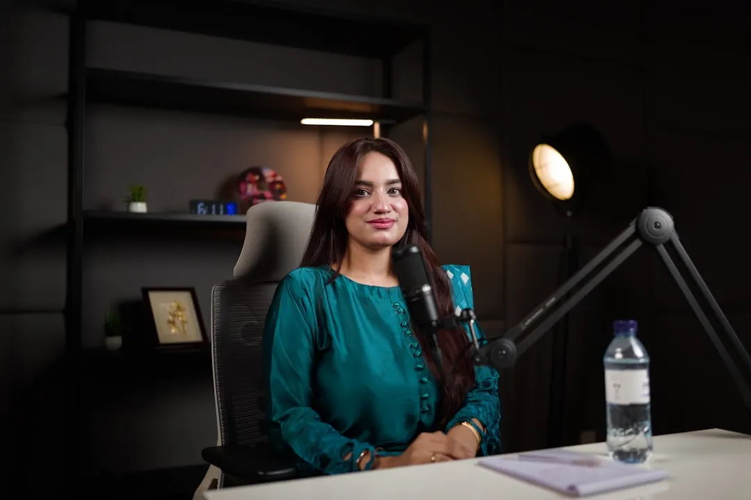 Woman recording a podcast at a professional microphone in a studio setting for thought leadership content