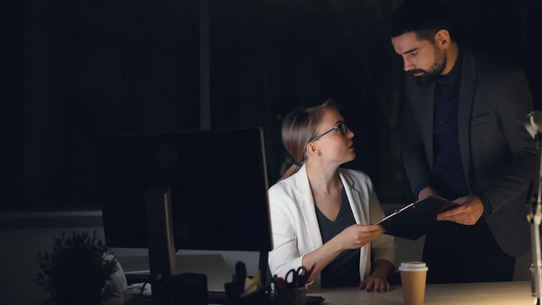 Woman business professional reviewing contract documents at her desk