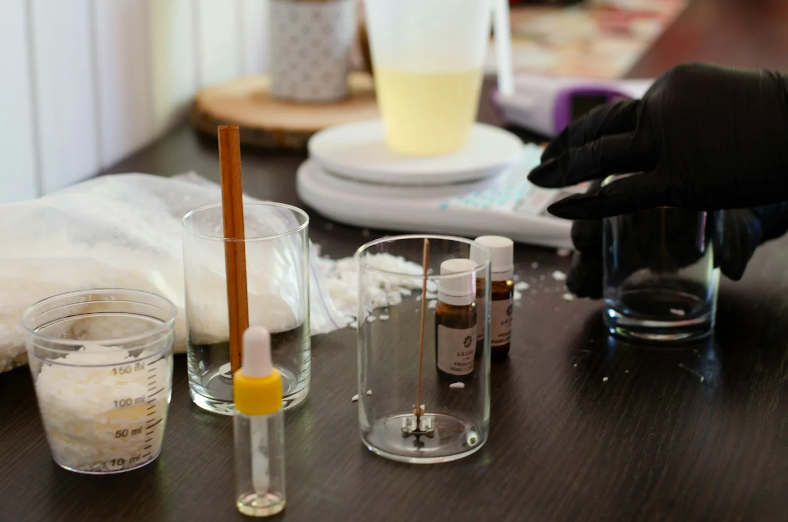 Small-batch skincare ingredients and tools on a wooden workbench