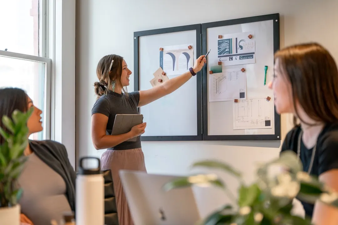 Woman entrepreneur planning strategy at whiteboard with calendar timeline