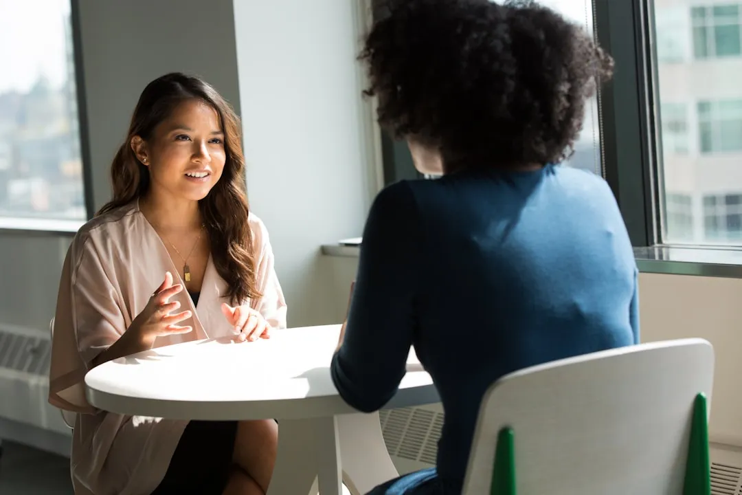 Woman business owner in professional meeting with a lender across a desk