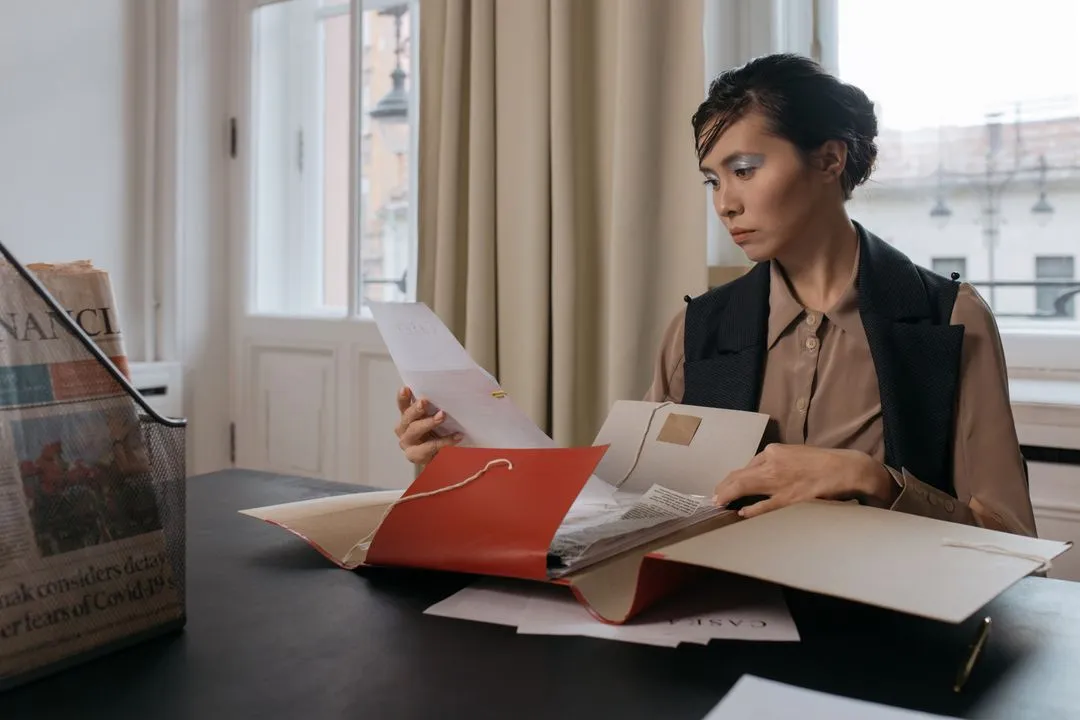 Businesswoman reviewing documents with focus and determination