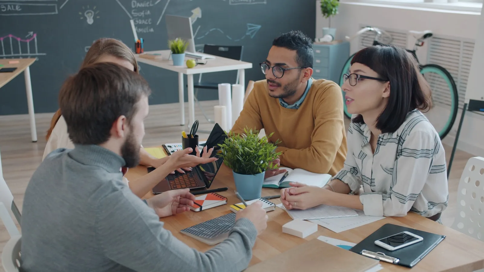 Small creative agency team collaborating in a modern office