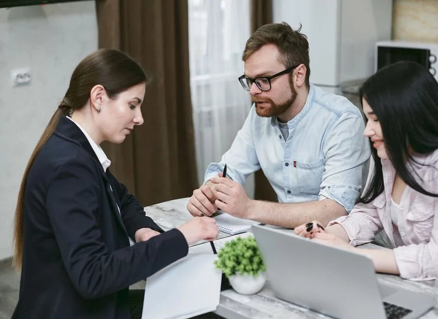 Woman entrepreneur in a meeting with a financial advisor discussing business loan options