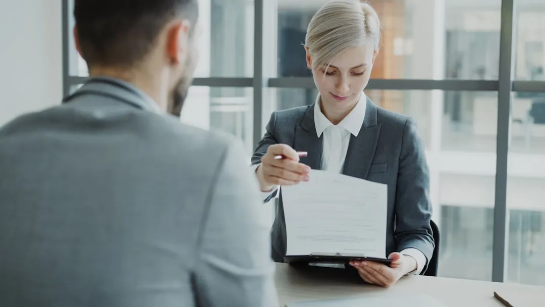 Woman entrepreneur comparing financial documents and capital options